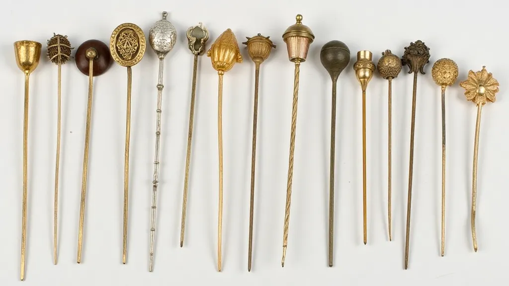 Assortment of antique hat pins with diverse maker's marks